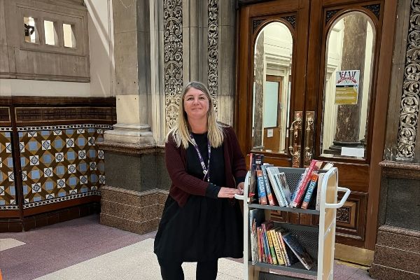 Lou with a trolley of books at Leeds Library