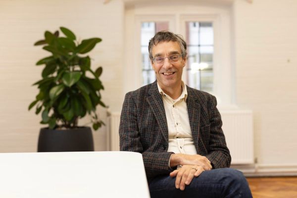 Profile of a sitting Piers Forster