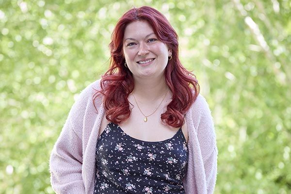 Stephanie stood in a grassy area, smiling.