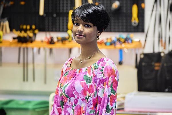 Tanvi stood smiling in a workshop.