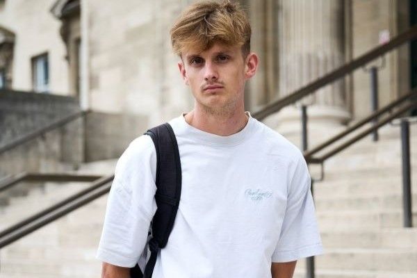 Portrait of Romy Hardwood Walton standing on the steps outside the Parkinson building.
