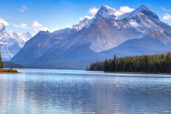 A lake surrounded by trees and mountains