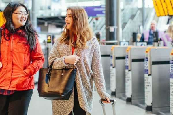 Two students walking out of Leeds Train Station