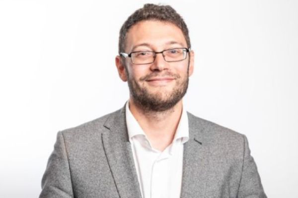 Professor Alessandro Biraglia, smiling at the camera.