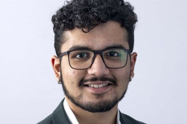Vaibhav Pramode Nair looking at the camera and smiling.