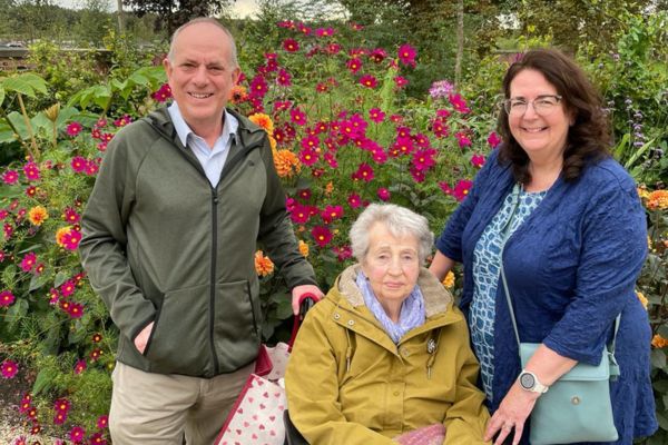 Rosie Woollard in a colourful garden with her two children, Bernard and Sue on her 91st birthday.