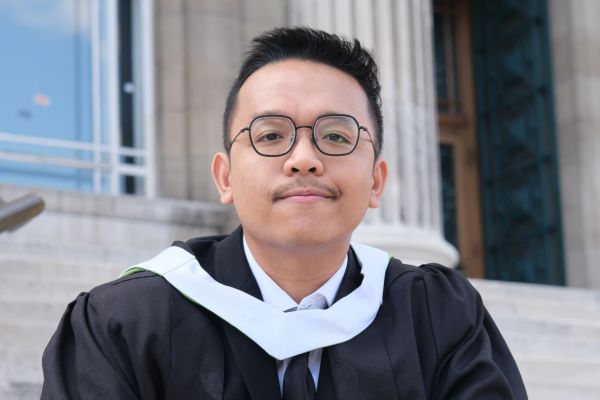 Chairil Gibran Saragi Turnip in their graduation gown.