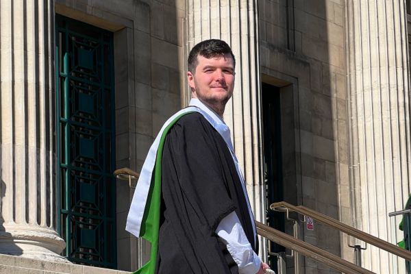 Lewis Mason in their graduation gown.