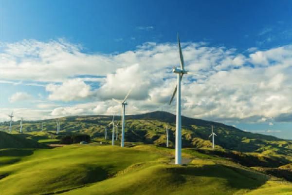Wind turbines on rolling hills on a bright, sunny day