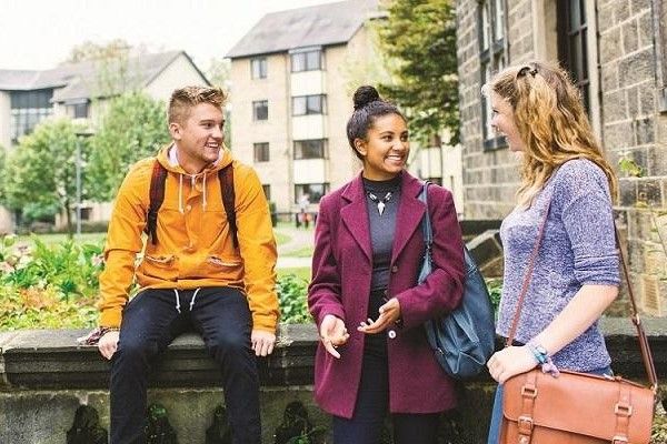 A group of students chatting outside the entrance to Oxley residence