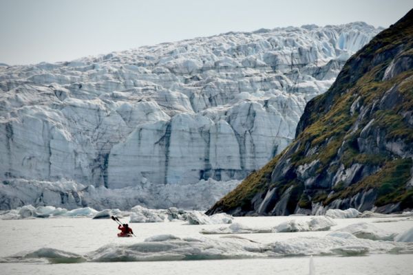 Two people in a canoe on ice marginal lake in southwest Greenland