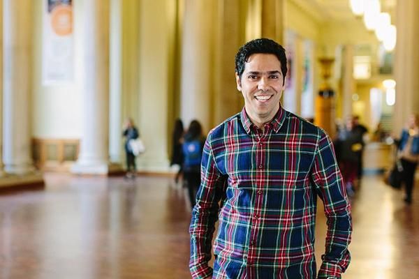 A Masters student standing inside the Parkinson Building