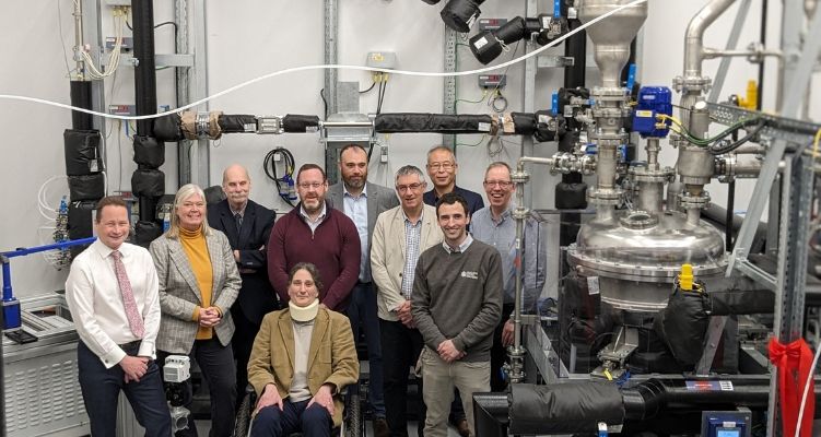 University staff in front of equipment in new nuclear research facility