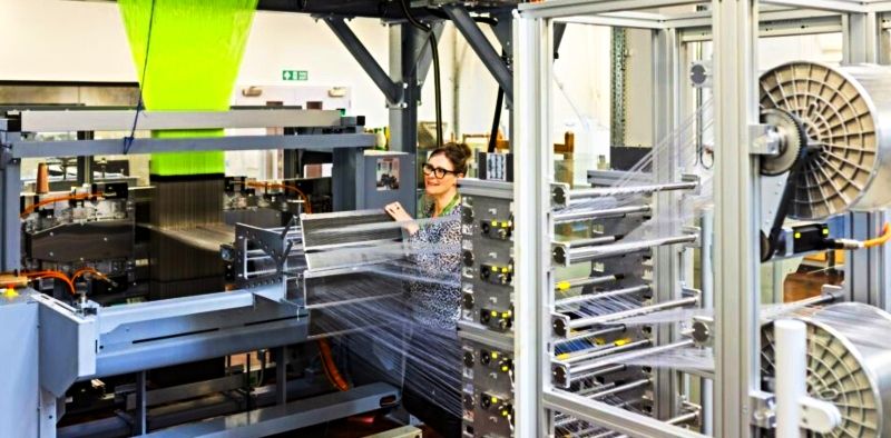 Dr Lindsey Waverton Taylor is seen attending a 3D weaving machine in the Innovation Centre at the University of Leeds.
