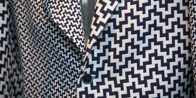 A close up of a herringbone patterned suit