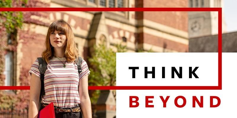 A student in front of the Great Hall on a sunny day. Text says Think Beyond.