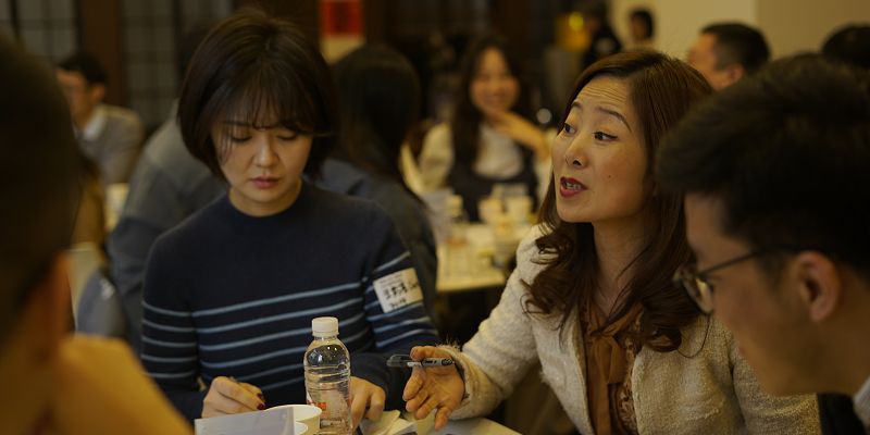 Individuals in discussion around a table