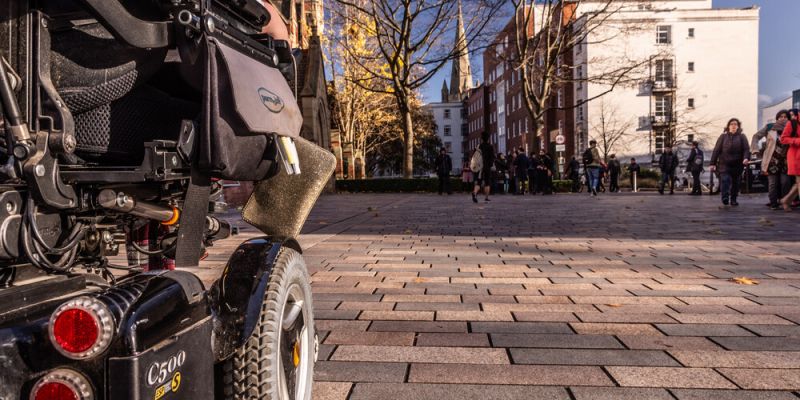 The bottom of an electric wheelchair on campus