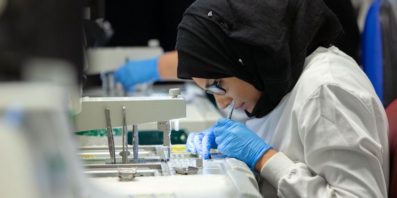 Woman working at a microscope