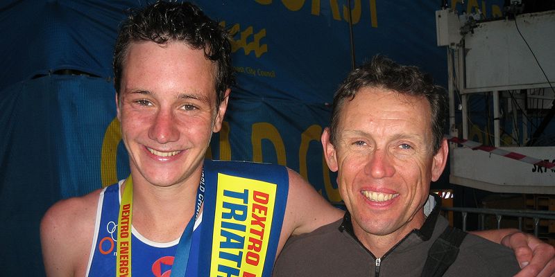 Jack Maitland and Alistair Brownlee stand arm in arm after a race