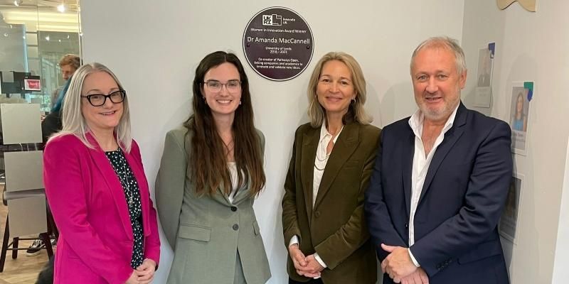 Chantelle Reeves, Amanda MacCannell; Margaret Korosec and Brian Baillie stand in front of the purple plaque.