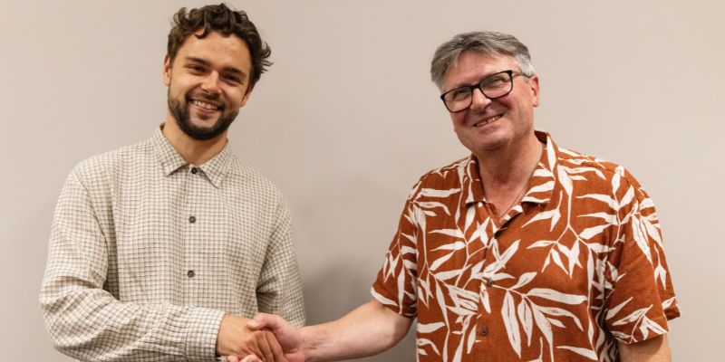 Tom Pyle (left) shakes hands with Simon Armitage (right)