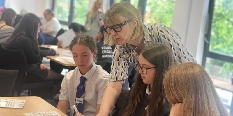 Rachel Beddoes talks to pupils at their desks