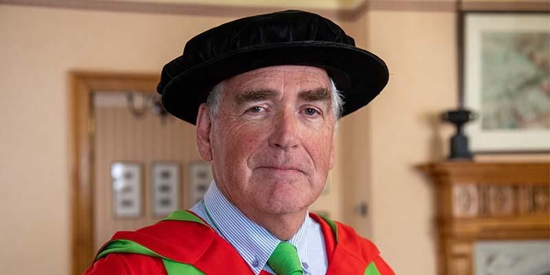 Headshot of David Gray in a graduation gown.