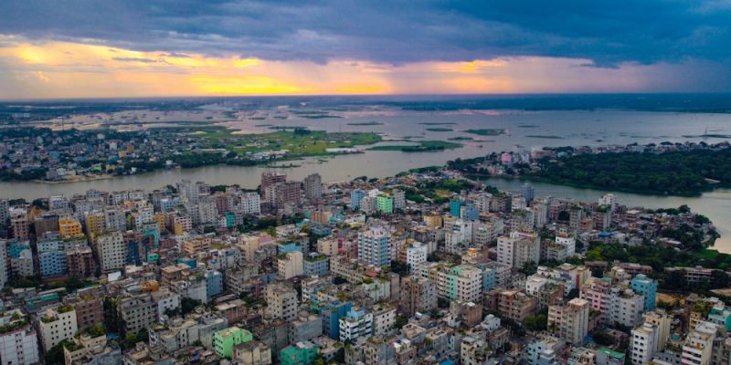 Aerial photo of a suburb of Dhaka, Bangladesh, showing lots of high rise building packed closely together. Adobe Stock