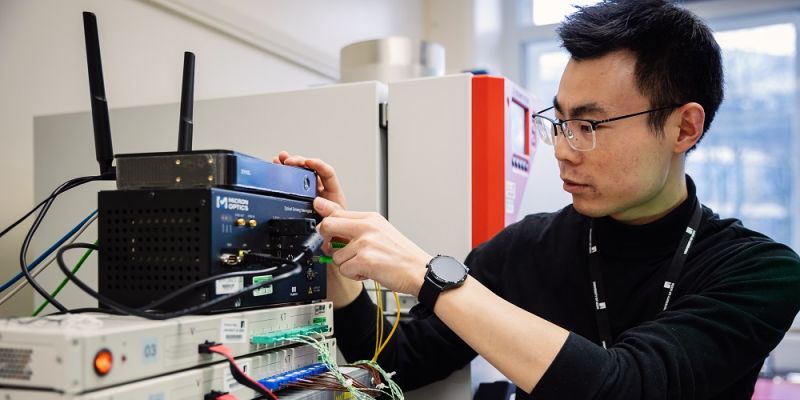 A person adjusting an electrical control system