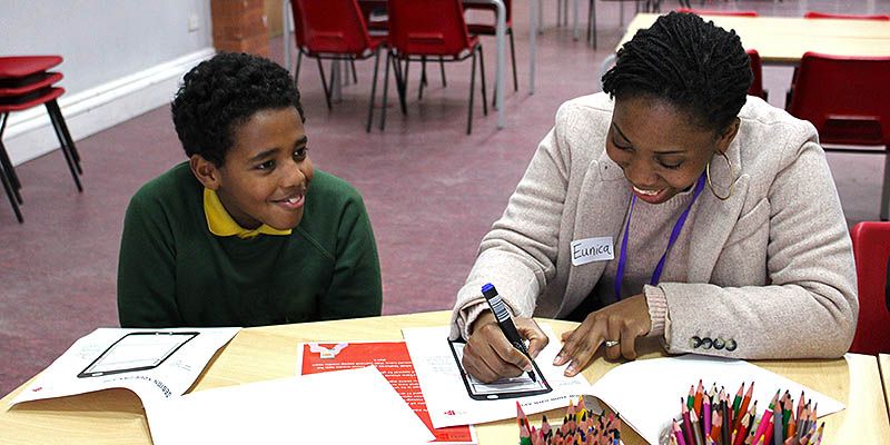 Eunica mentoring a student in a school.