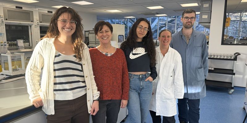 Five researchers stood in a lab.