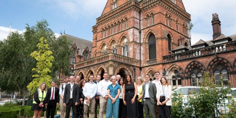 Dame Angela McLean and a large group of people stood outside the Great George Street entrance of Leeds General Infirmary.