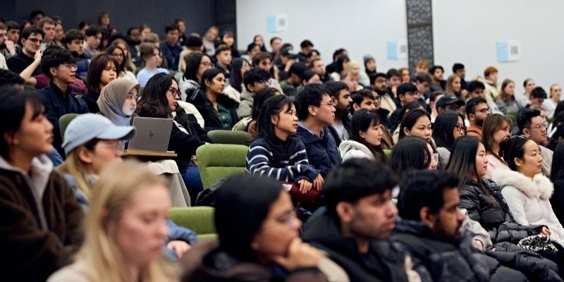 A lecture hall of students listening to Alex's talk.