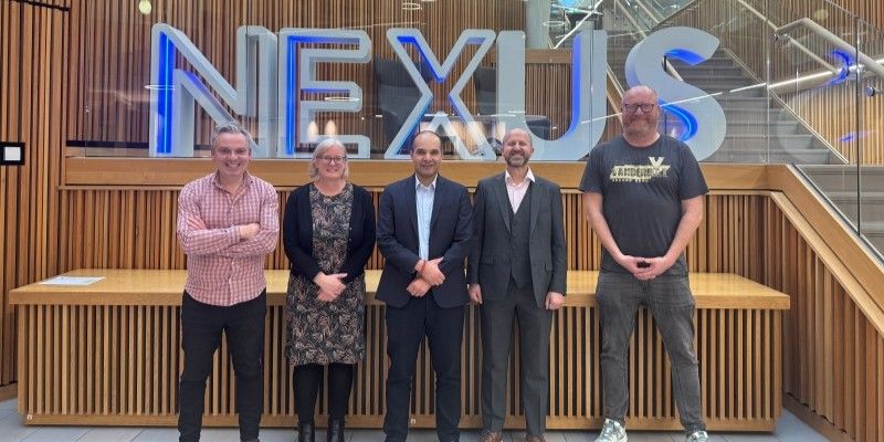 Glenn McCauley, Professor Cath Noakes, Gabriel Luis, Professor Rob Sturman, Barry Singleton in front of the Nexus sign in the Nexus building. 