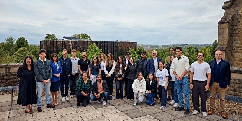 A large group of students with the panel of business experts and programme leaders.