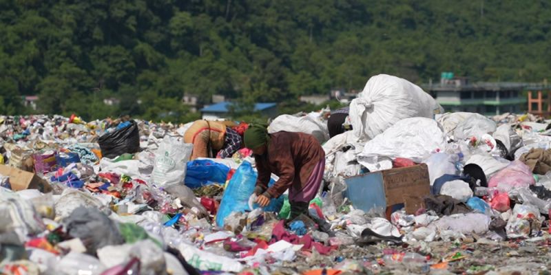 Person scavenges on a landfill site in South Asia. Photo credit: HERD International