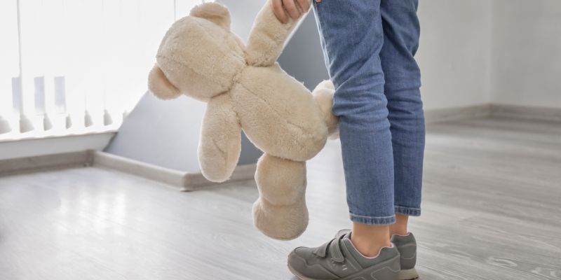 A child holds a teddy bear