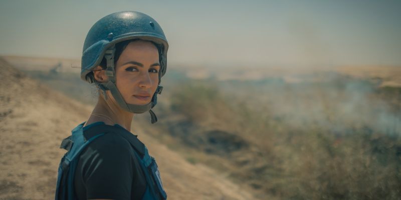 Hind Hassan wearing a Press vest and helmet in Iraq