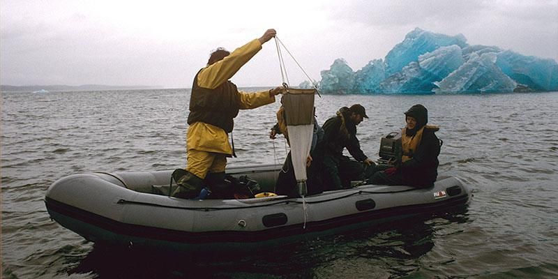 3 ocean researchers on inflatable boat