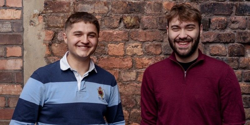Nikita Dumitriuc and Dragos Popa stood in front of a brick wall.