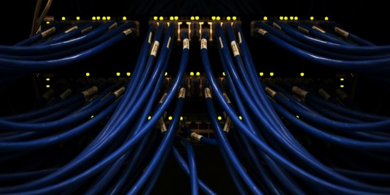 Numerous blue wires feed into a lit-up switchboard.