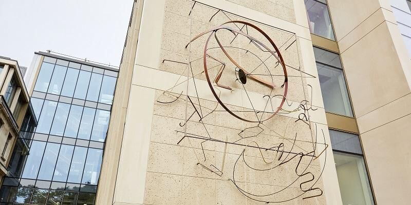 The image shows the new artwork on the side of the Henry William Bragg building at the University of Leeds. It is a collection of shapes that convey science - and make a connection to the city's creativity, says the artist