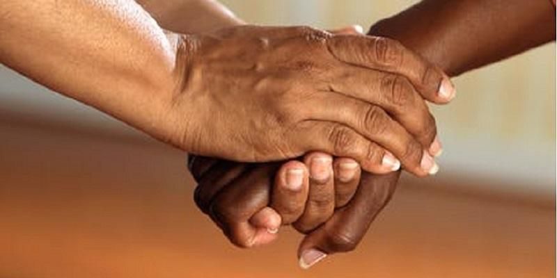 Image shows someone being given a helping hand - a sign of support.