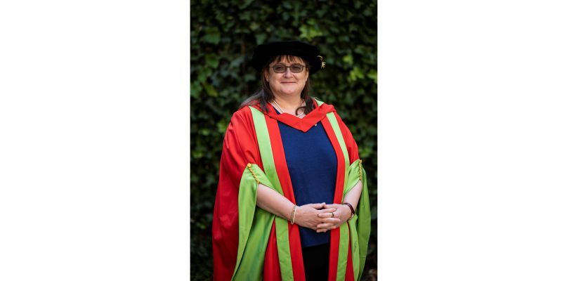 Rachel Lord wears University of Leeds honorary graduate robes and smiles at the camera