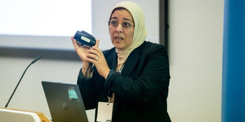 Rania Maklad, CEO of Ocuwell pitching at the Startup World cup holding the Ocuwell device in their hands. 