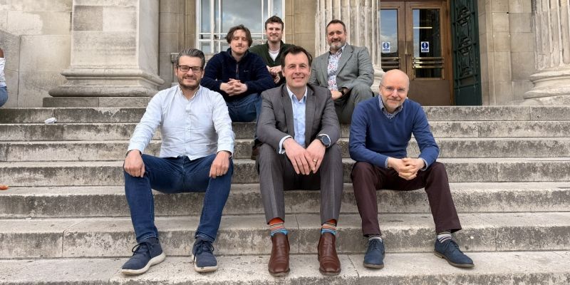 Six men representing Switchdye amd John Hogg sat on steps