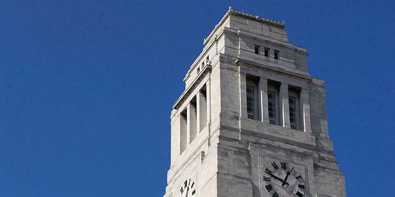 The top of the Parkinson Building tower against a clear blue sky