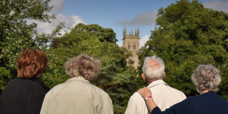Four people look at a church in Yorkshire.