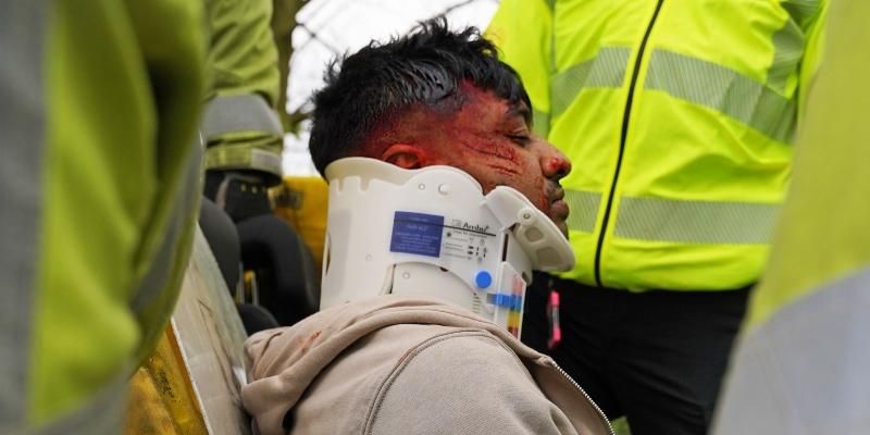 Emergency services take care of a victim of a car that crashed as a result of drug-driving bu putting on a neck brace.